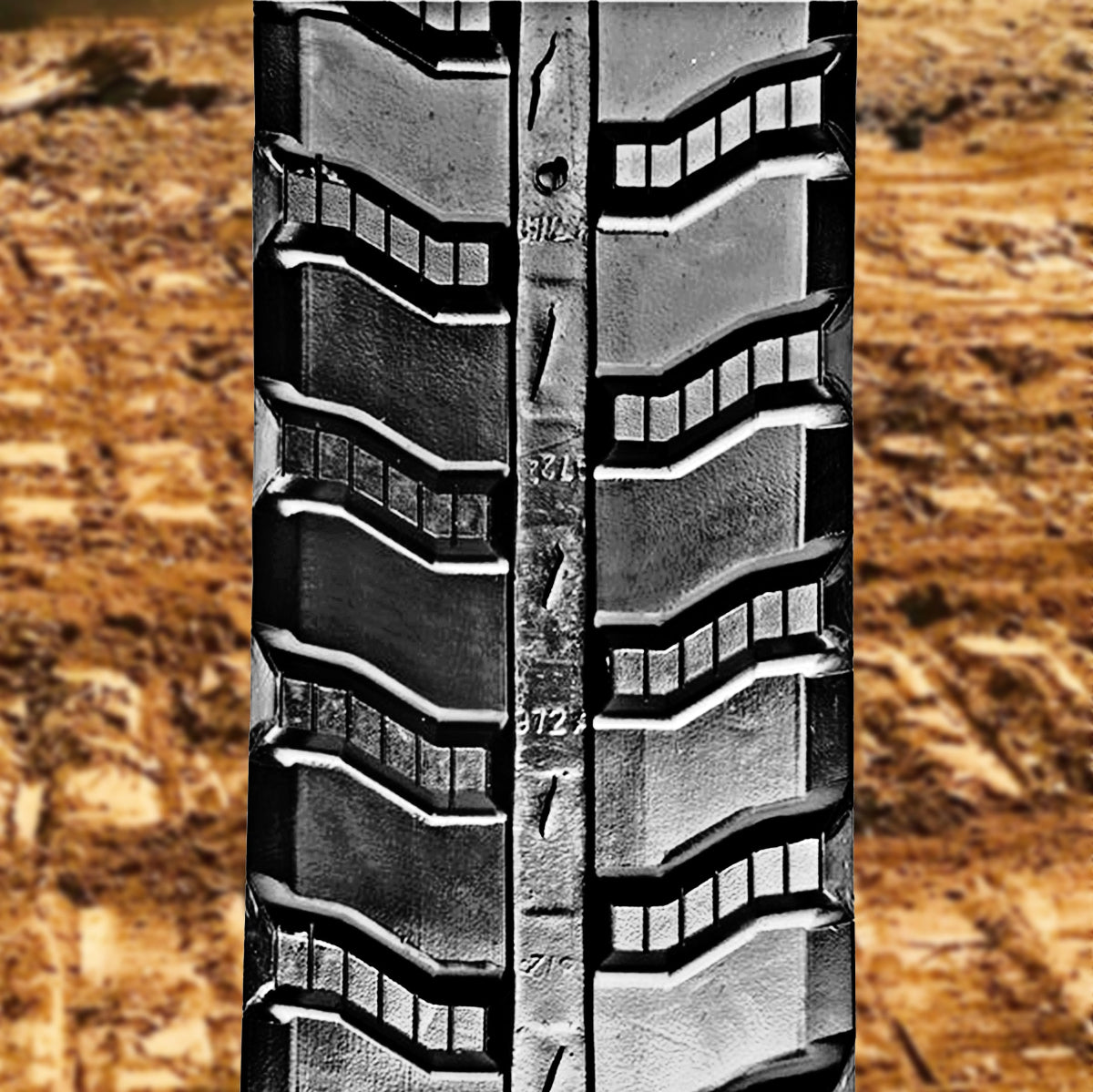 Front view of an S-lug rubber track tread pattern, highlighting its design for traction and durability on skid steers and mini excavators.